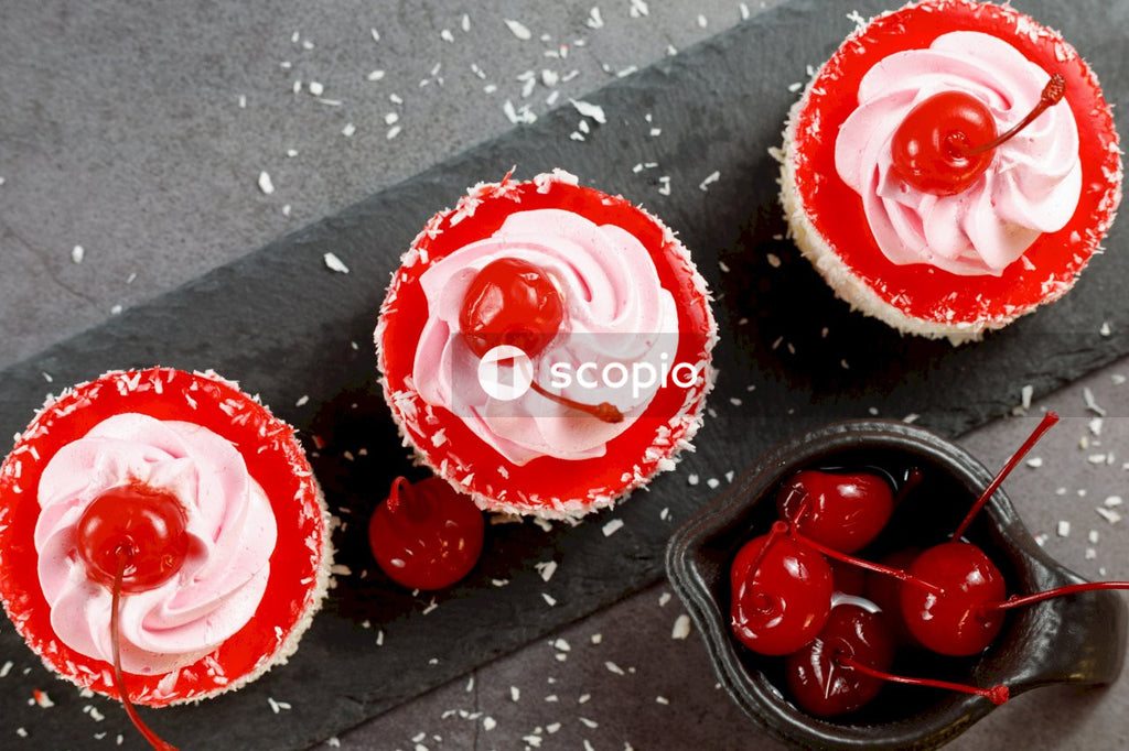 Red and white cupcakes on black surface