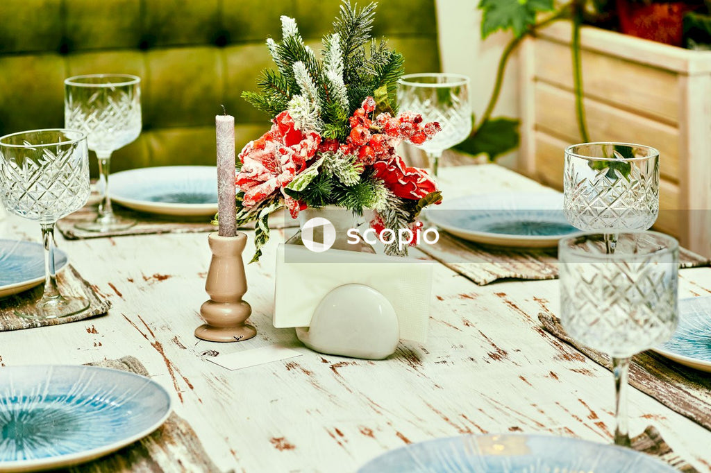 Red and white floral table cloth with candles