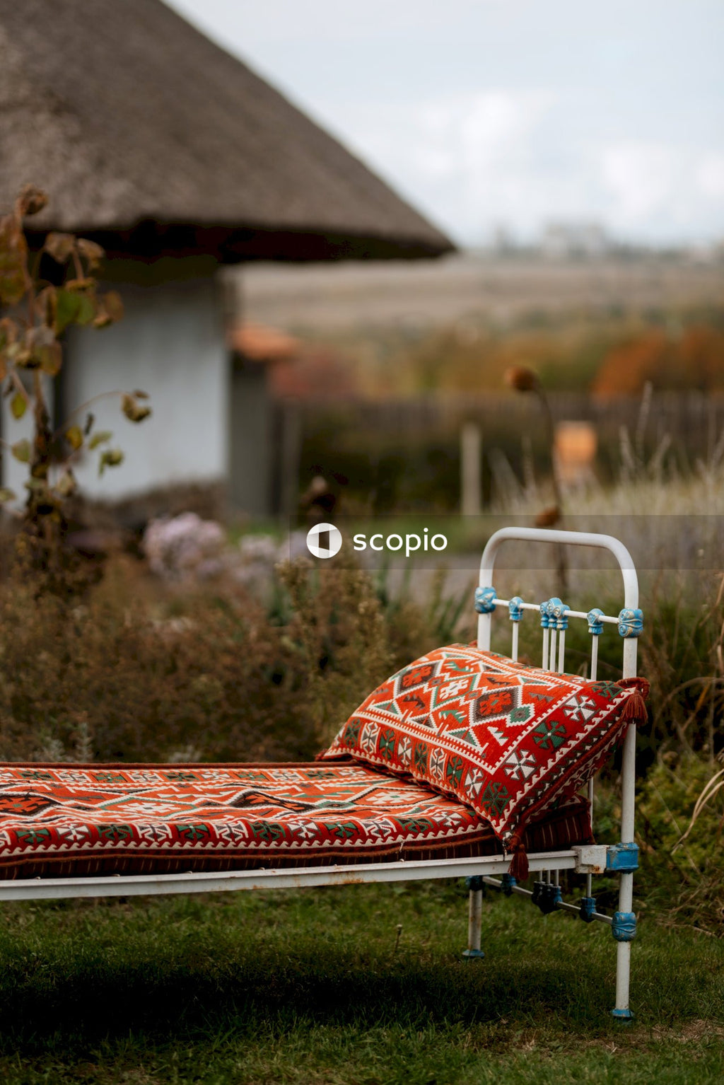 Red and white striped bed linen on green grass field