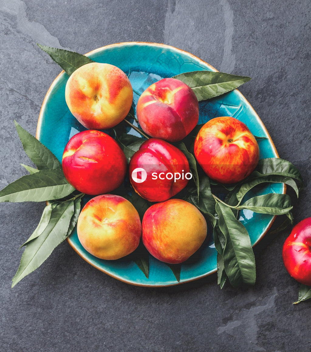 Red apples on blue and white floral ceramic plate