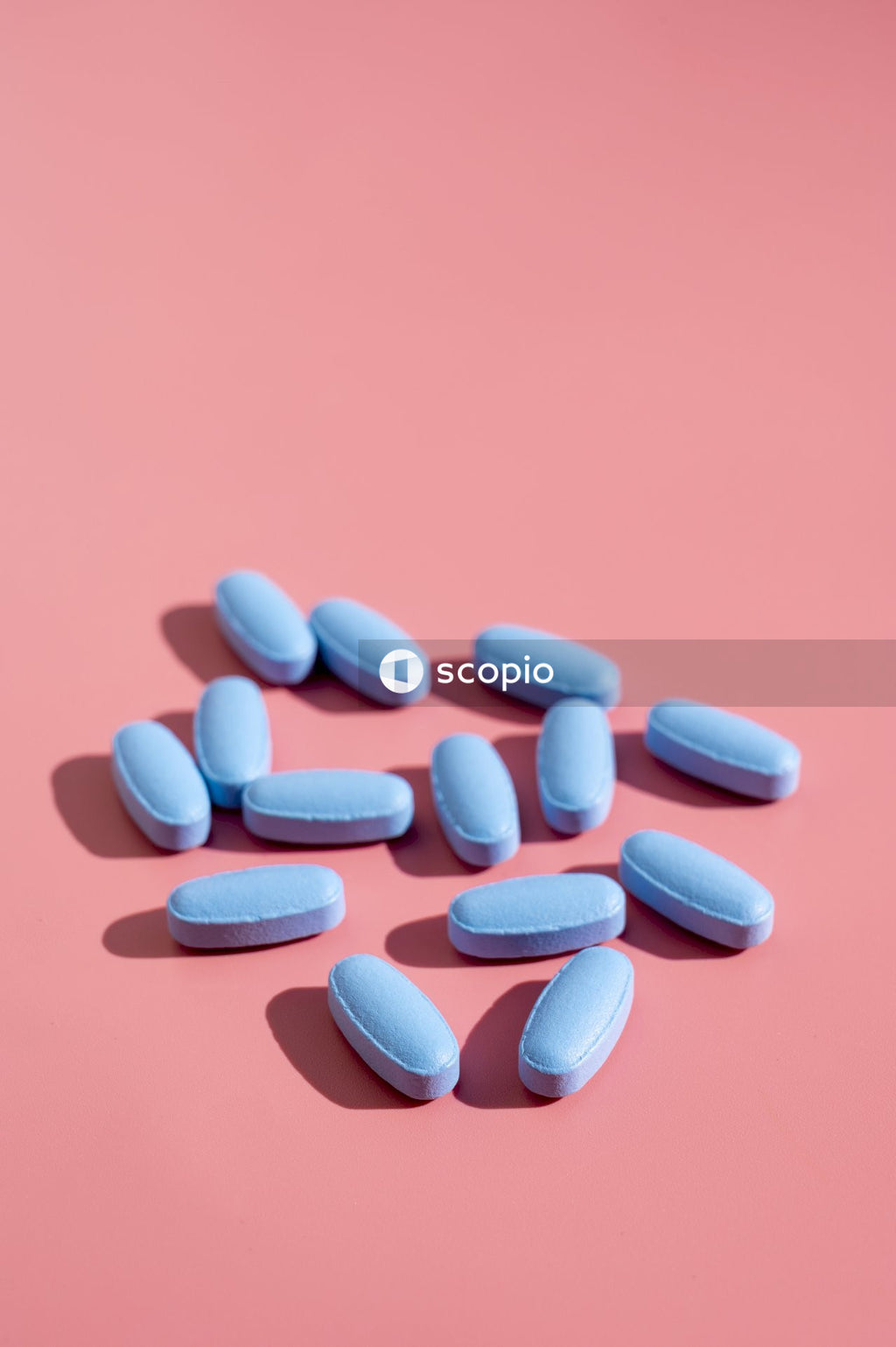 Red medication pill on red textile