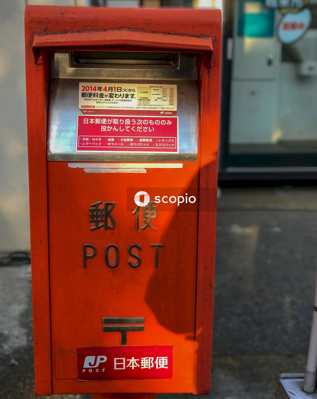 Red telephone booth on gray concrete floor
