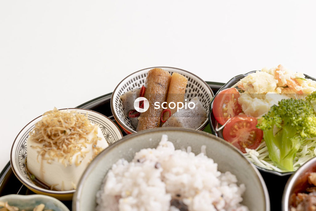 Rice on stainless steel bowl beside bread and sliced bread on white ceramic plate