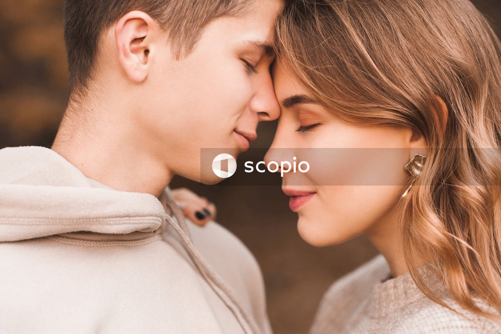 Romantic kissing teenage couple wear casual clothes in autumn park outdoor
