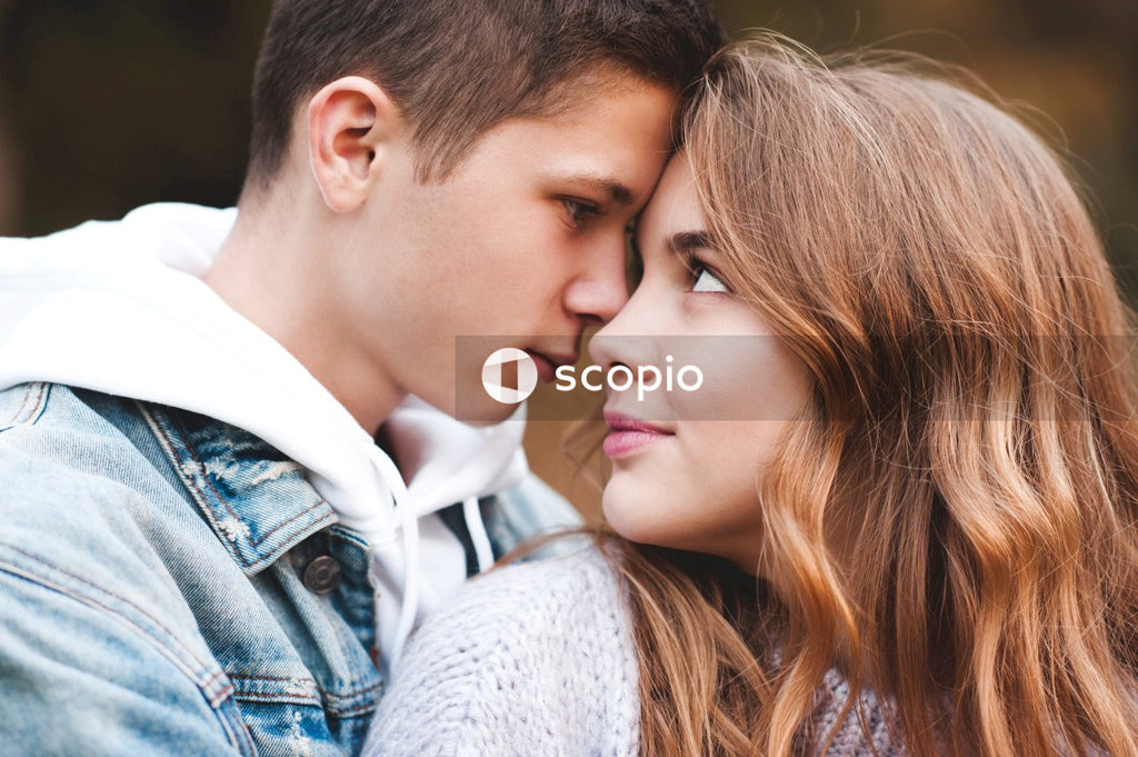 Romantic teenage couple wear casual clothes in autumn park outdoor