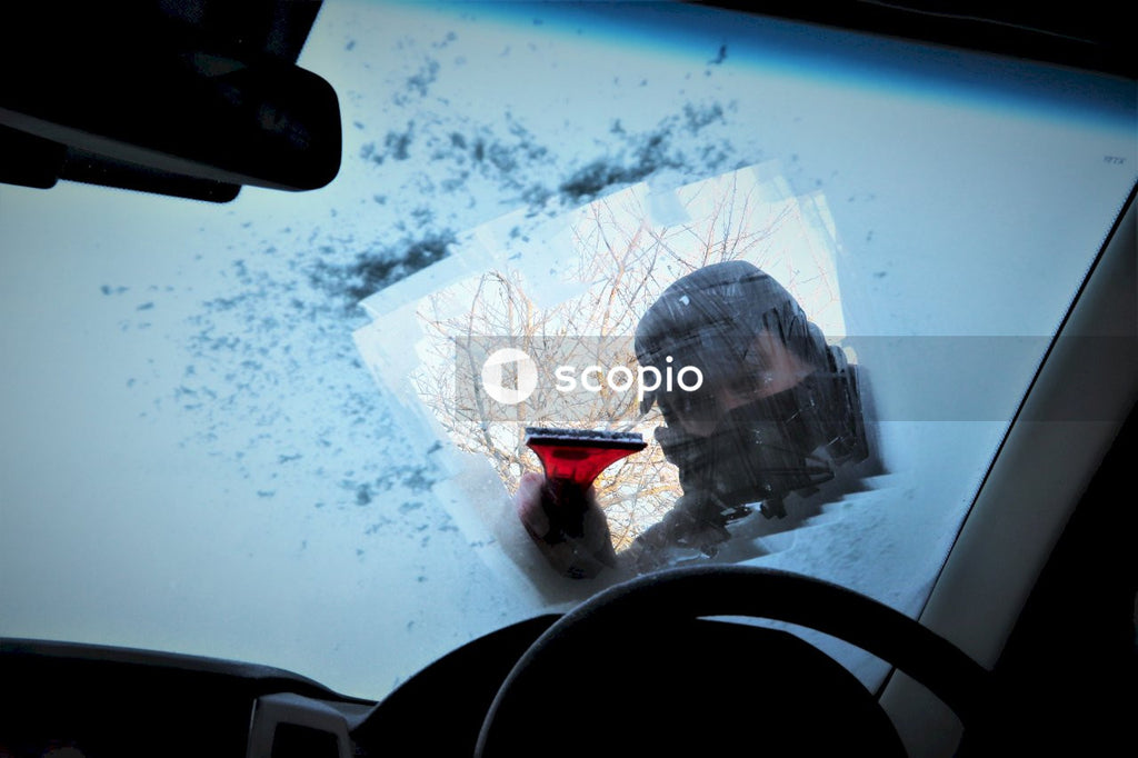 Scraping ice of the car windshield