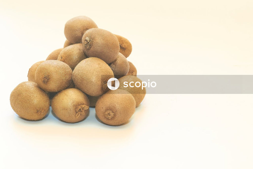 Several ripe tasty kiwis isolated on white