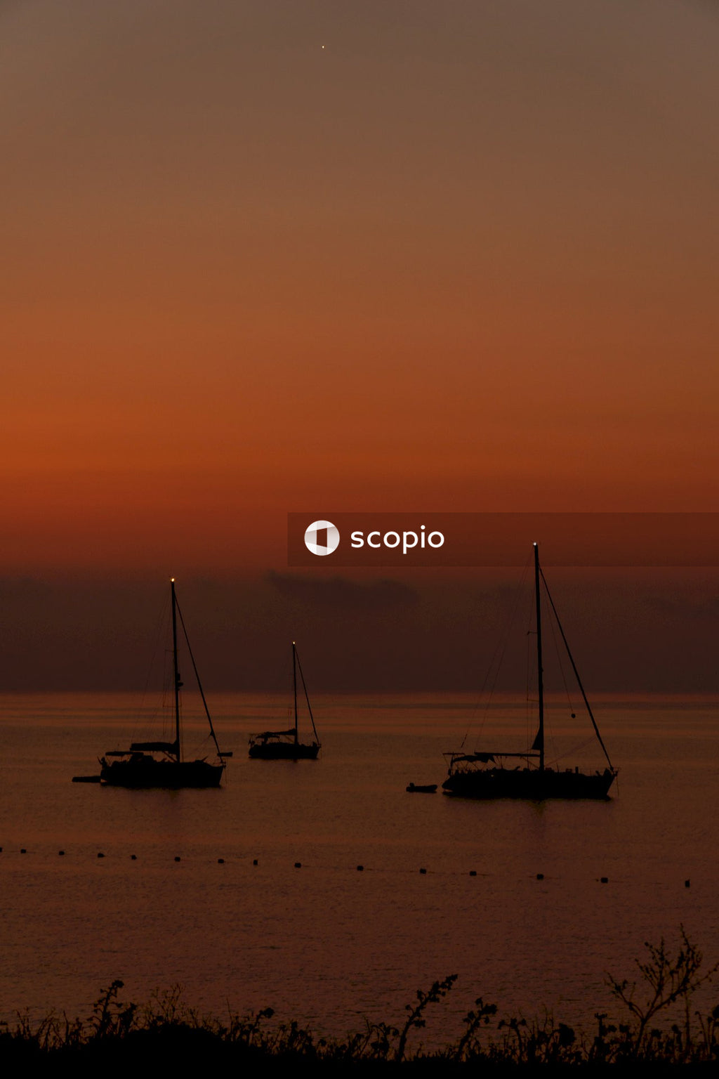 Silhouette of boat on sea during sunset