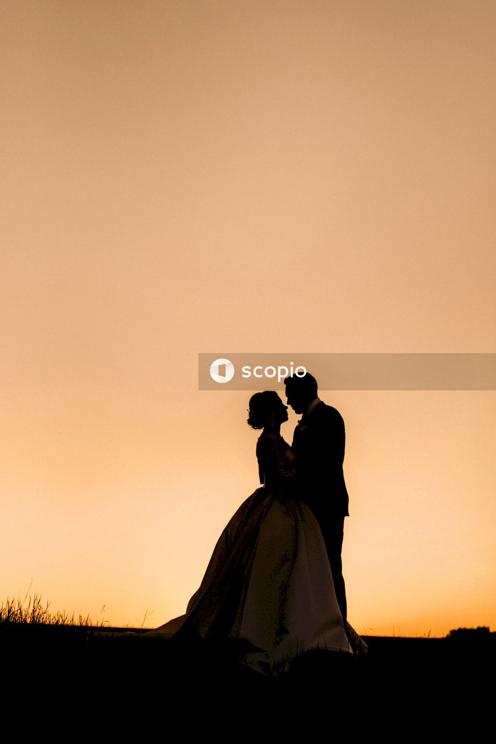 Silhouette of couple kissing during sunset