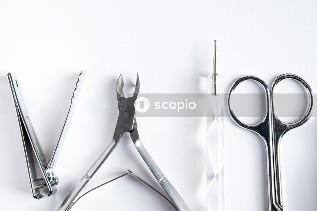 Silver and black scissors beside silver scissors