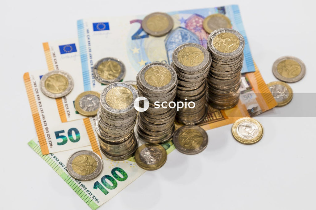 Silver and gold coins on white paper