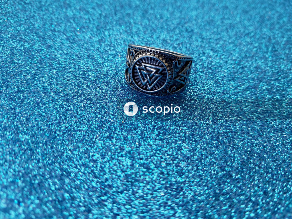 Silver diamond ring on blue textile