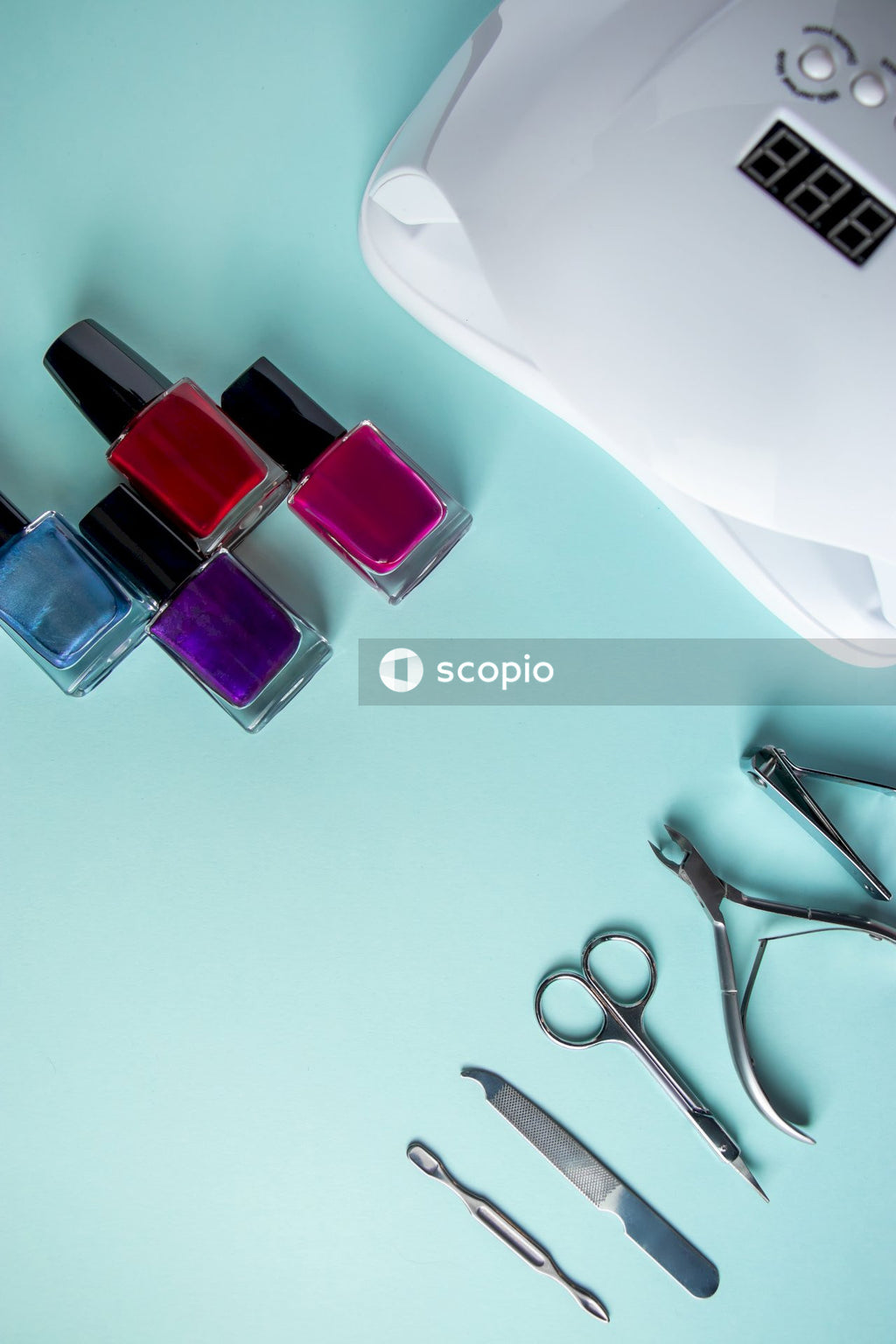 Silver spoon beside purple nail polish bottle