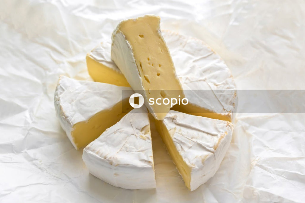 Sliced cheese on white ceramic plate