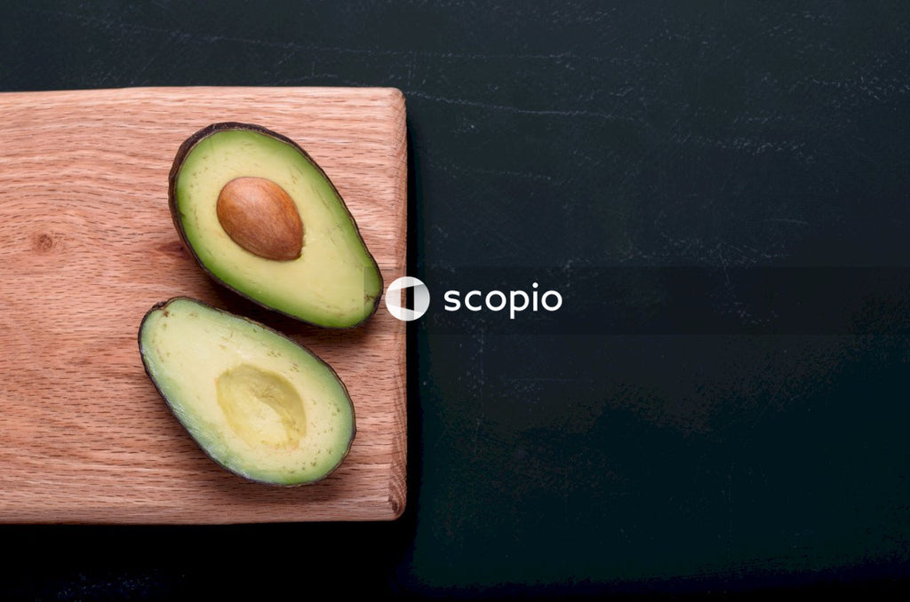 Sliced green fruit on brown wooden chopping board