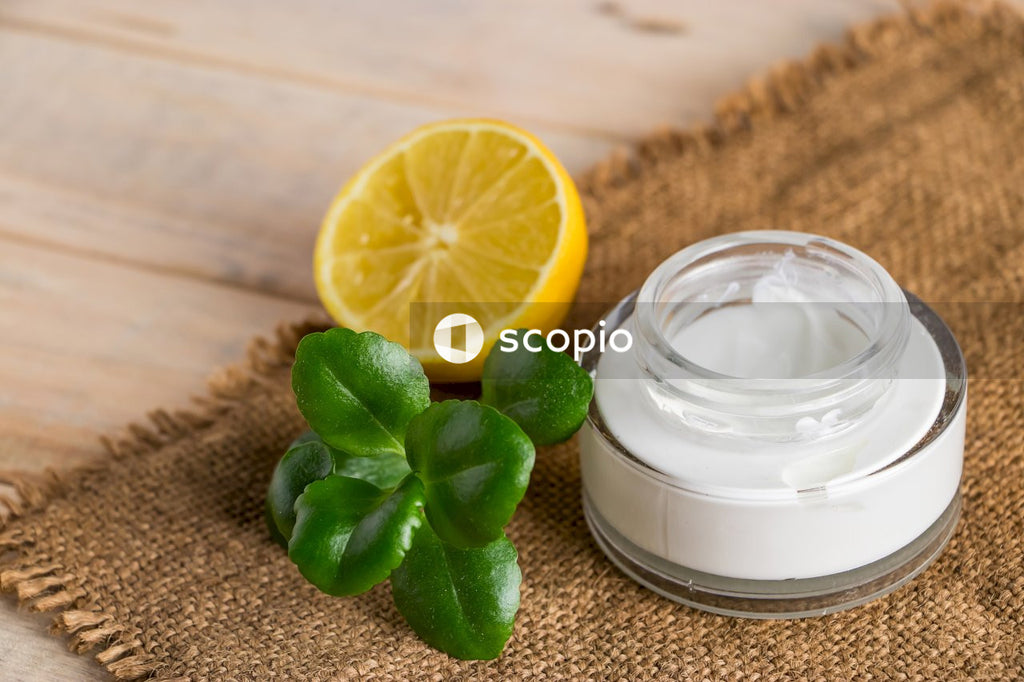 Sliced lemon beside clear glass jar with white liquid