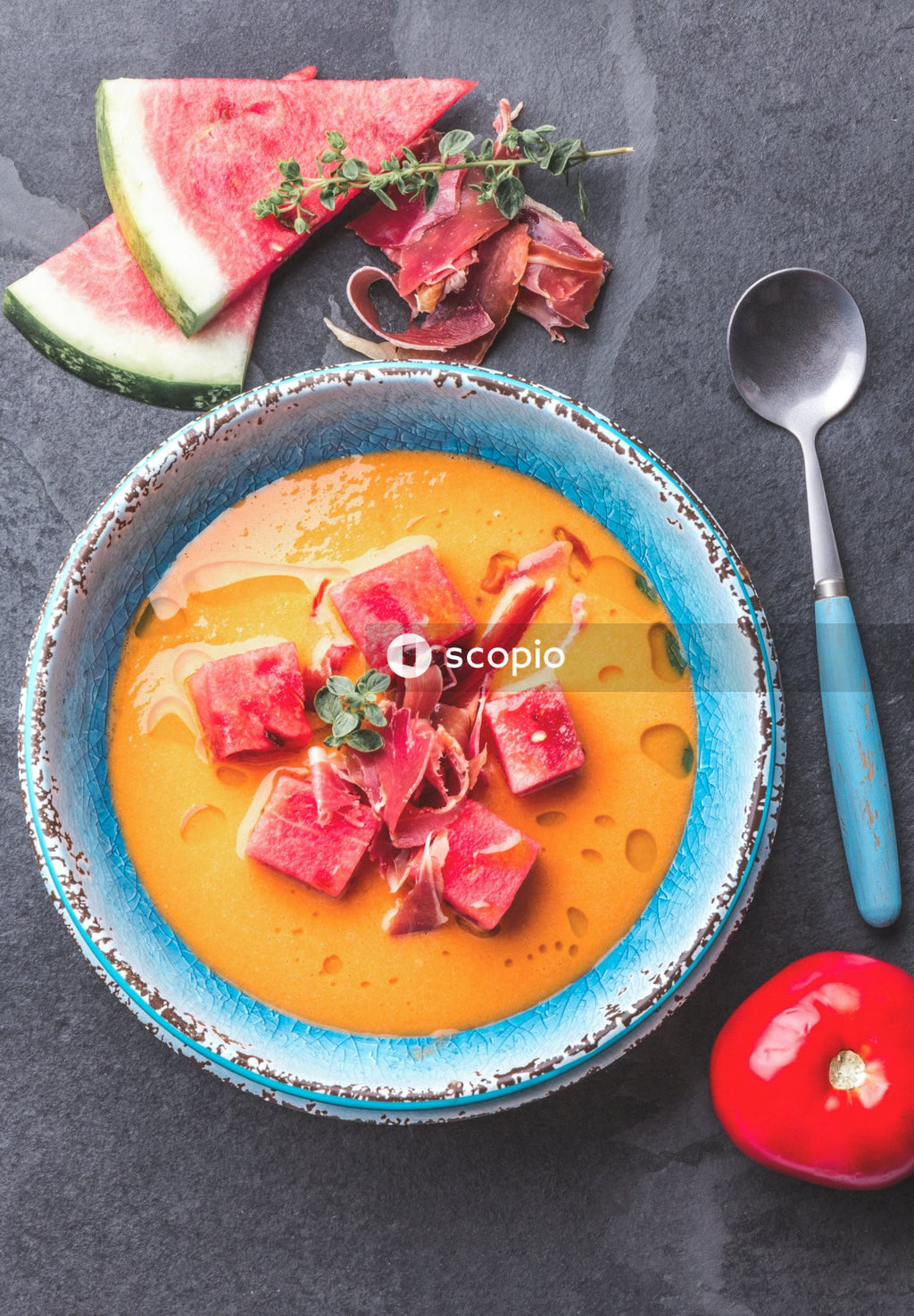 Sliced tomato and cucumber on blue ceramic bowl