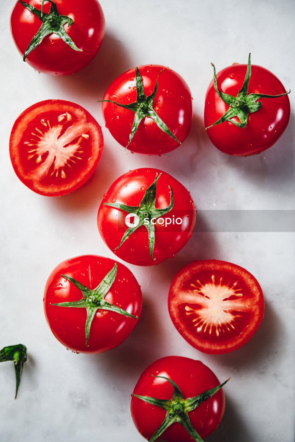 Sliced tomato on white table
