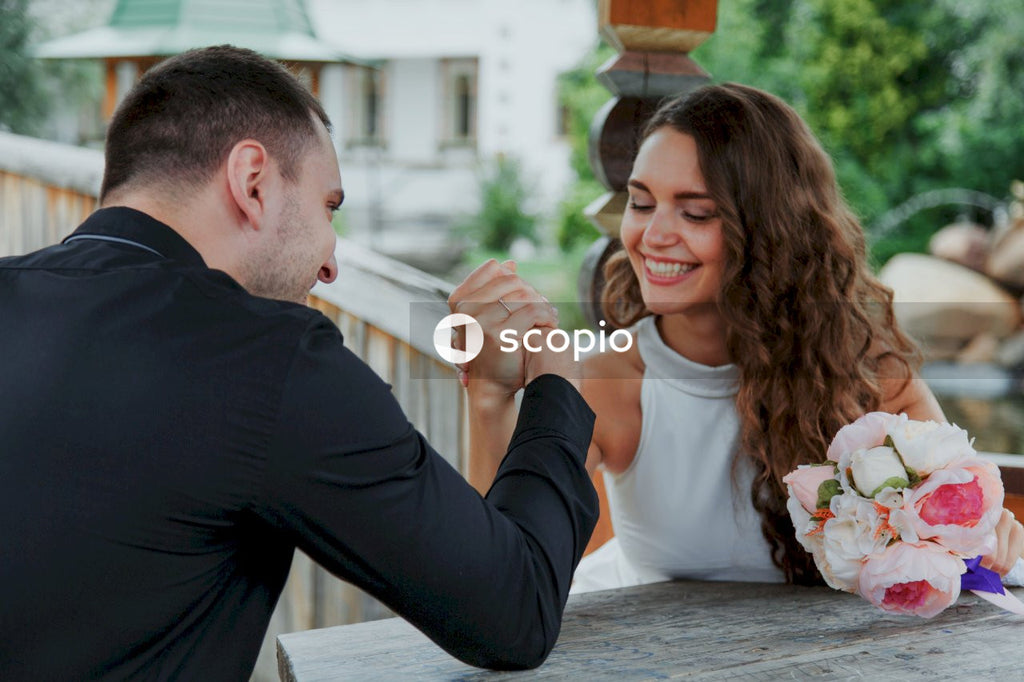 Smiling couple arm battling outdoor