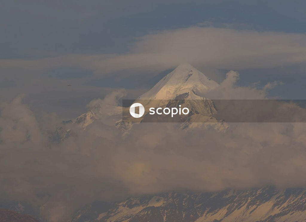 Snow covered mountain under cloudy sky