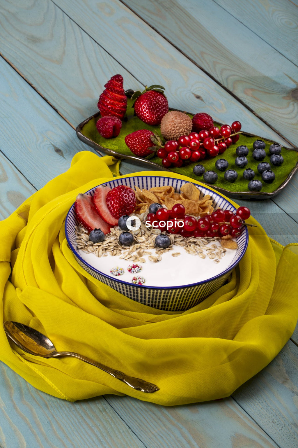 Strawberry and blackberry on yellow banana