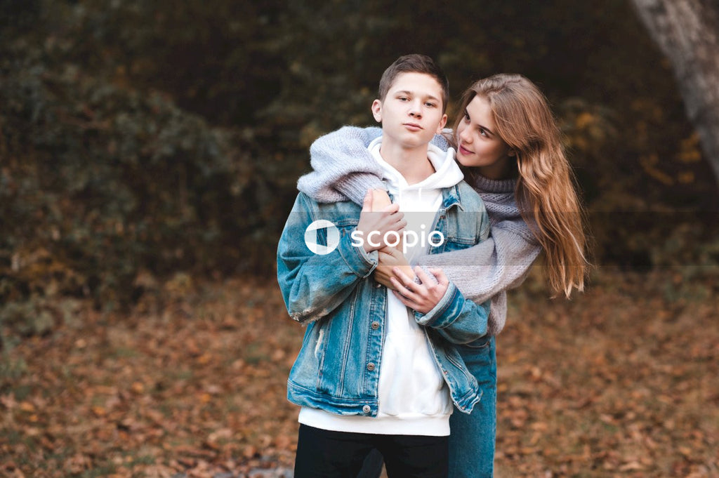 Teenage couple cuddling in the forest