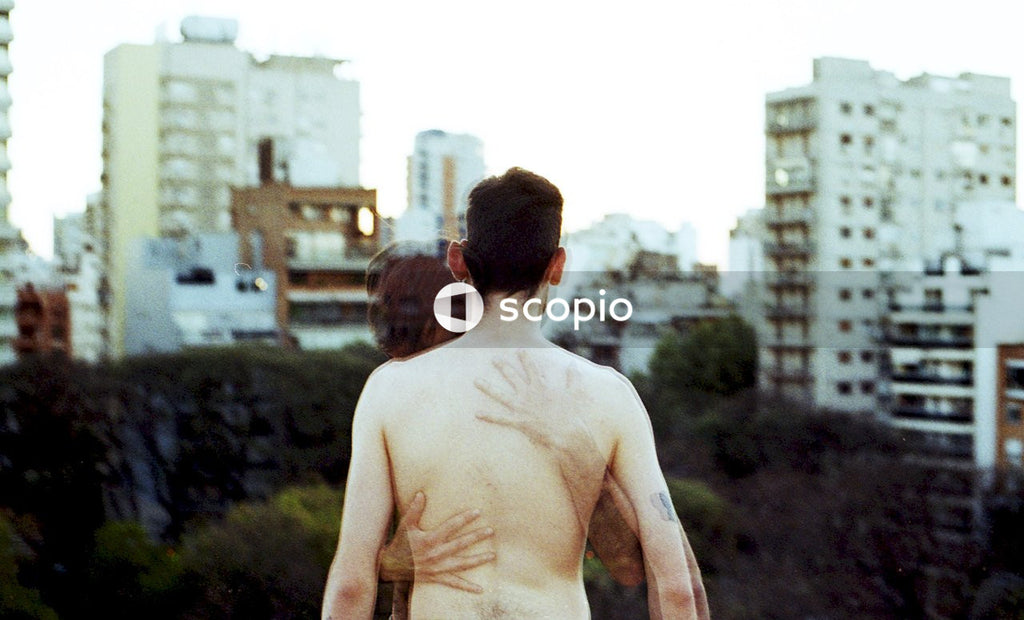 Graphic image of topless man hugging a ghost of young man outdoor
