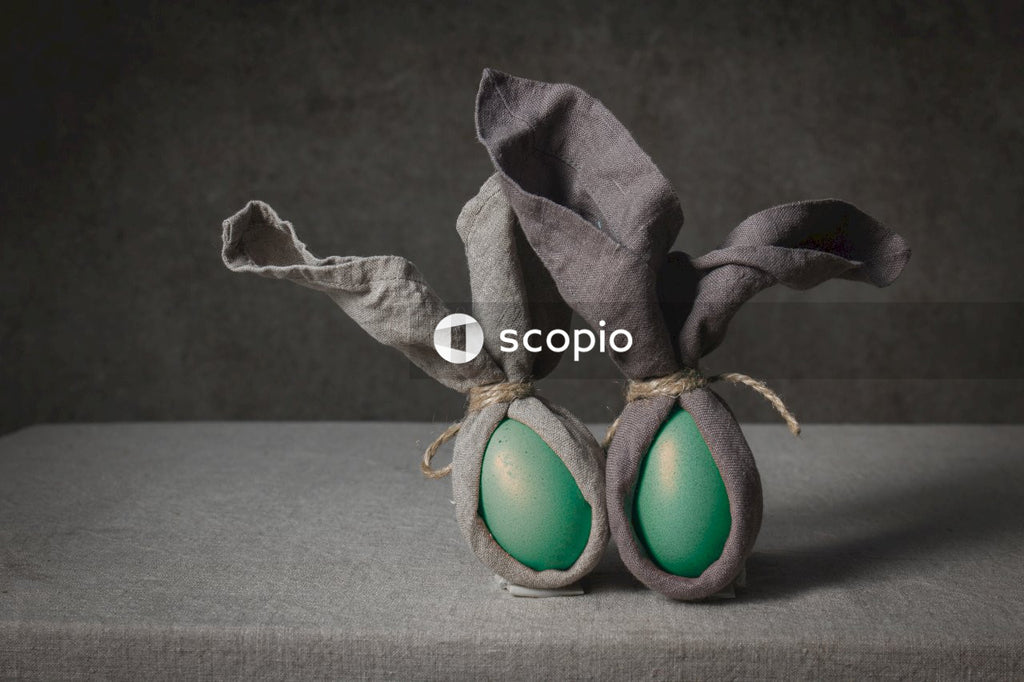 Two blue egg on brown textile