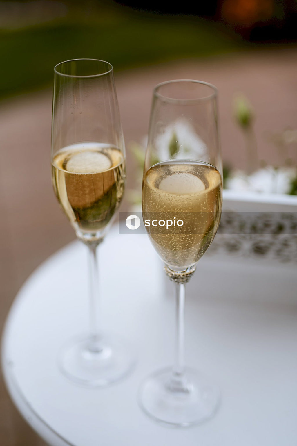 Two clear wine glasses on white ceramic plate