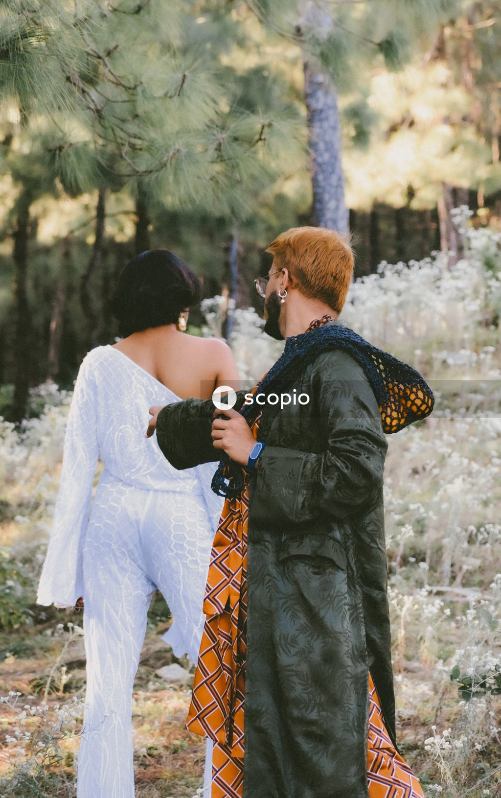 Two genderqueer man in stylish outfits having romantic moments outdoor in the nature
