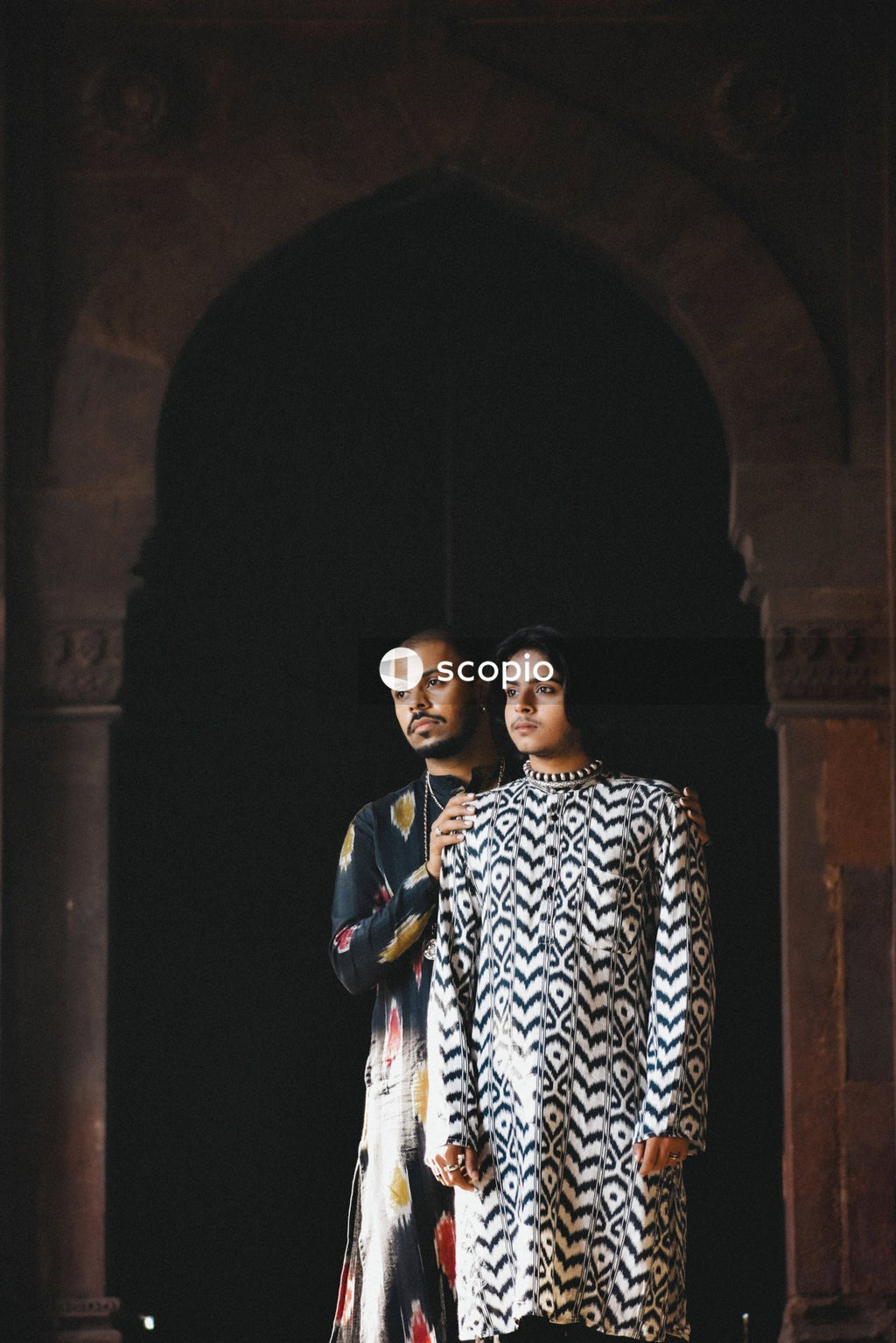 Two men standing beside each other