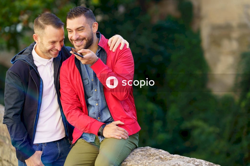 Two men talking on the phone and smiling