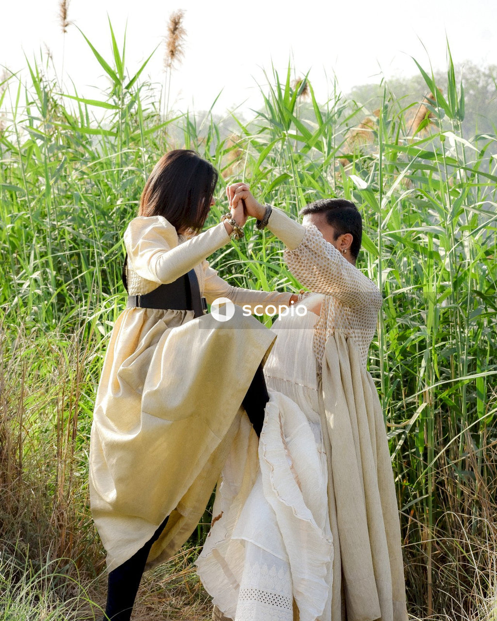 Two men wearing dresses dancing