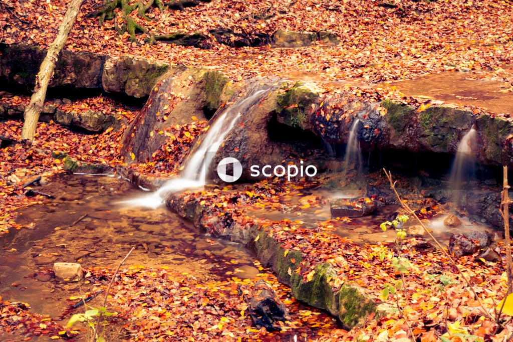 Water falls on brown rocky ground
