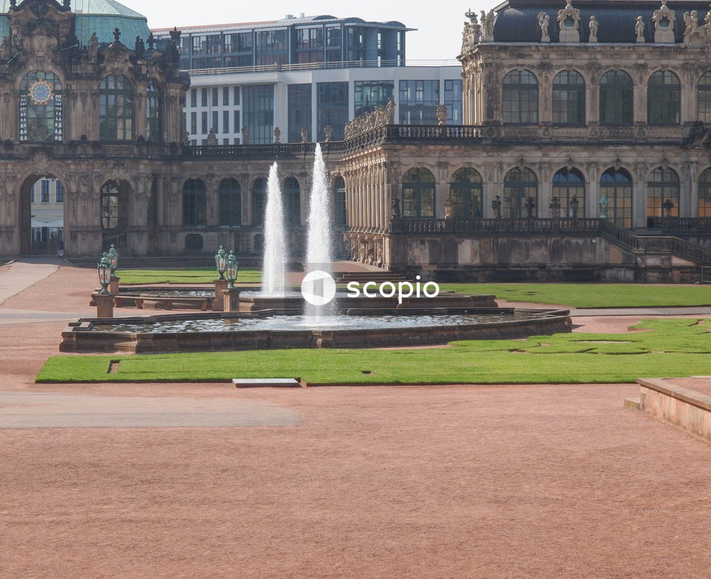 Water fountain in front of white building