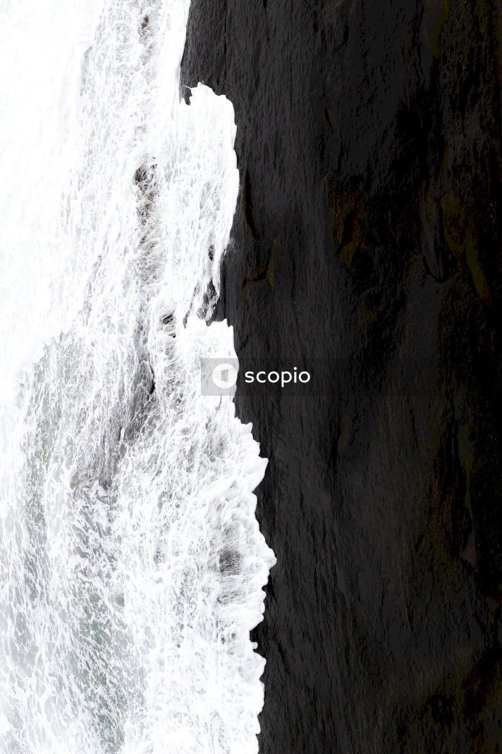 Water waves hitting rocky shore