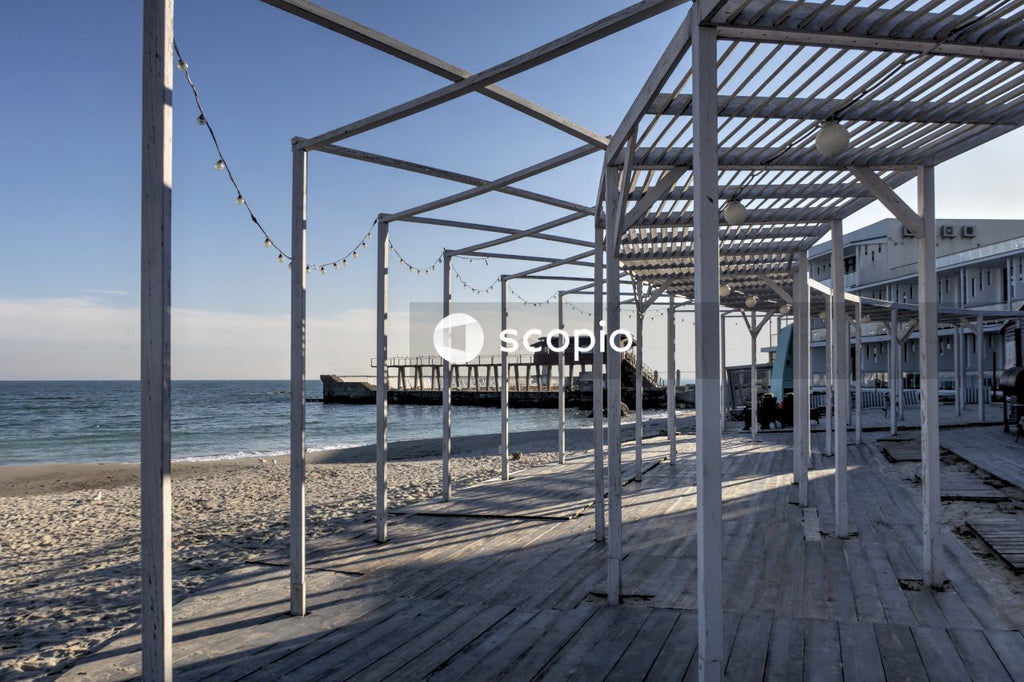 White and blue metal frame near body of water