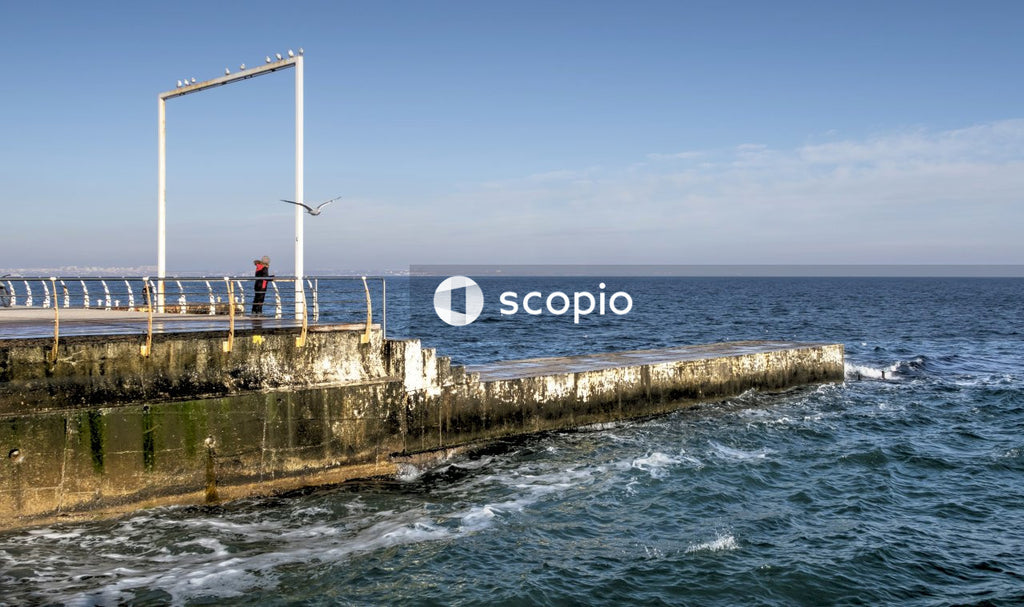 White and brown concrete dock on sea under blue sky