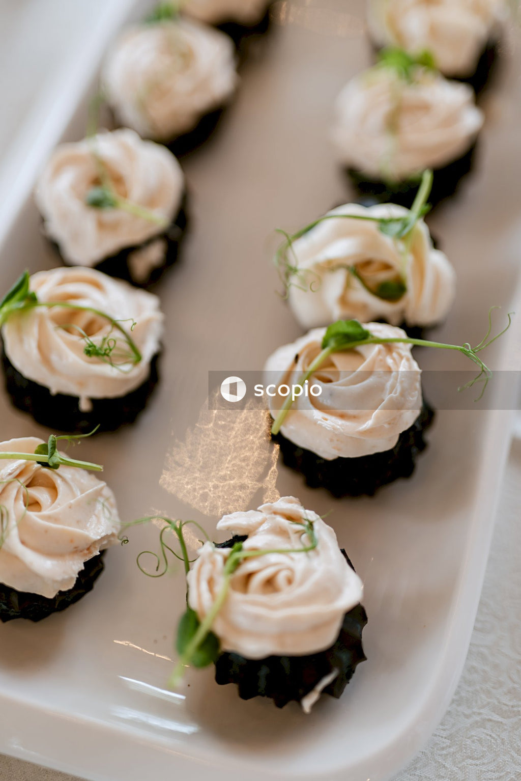 White and green flower on white ceramic plate