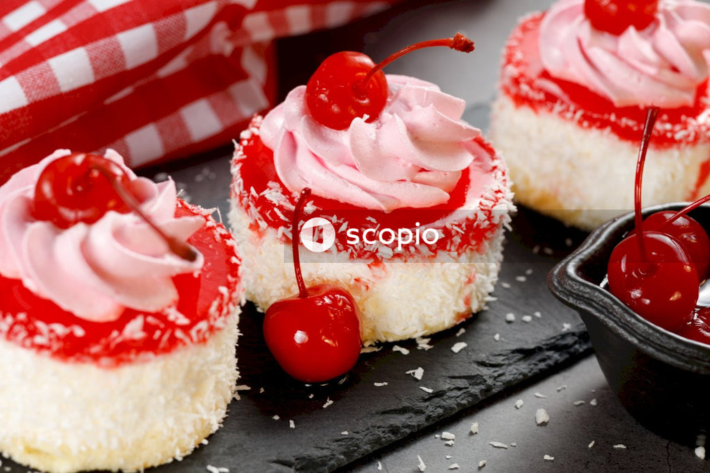 White and red cake on black table