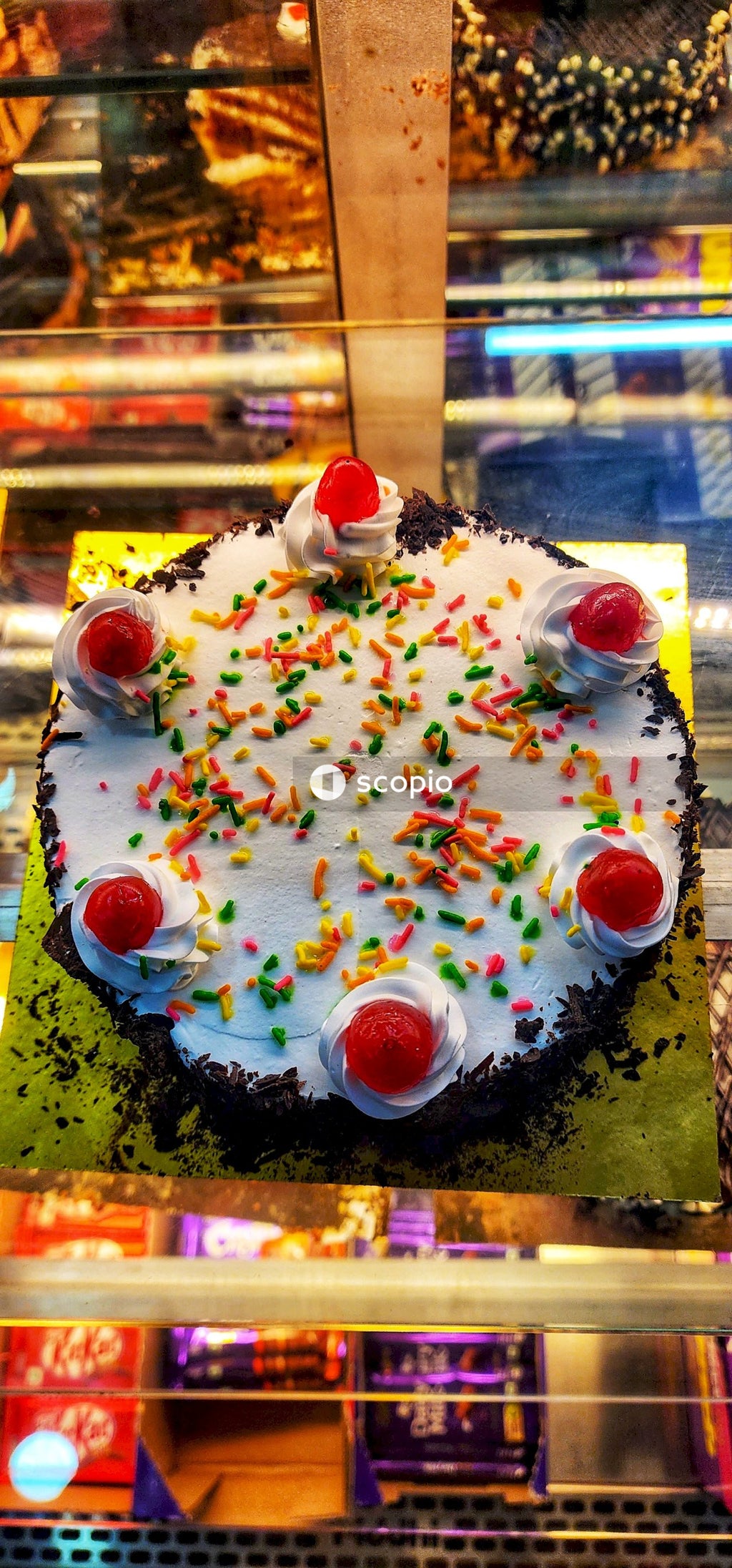 White and red cake with cherry on top