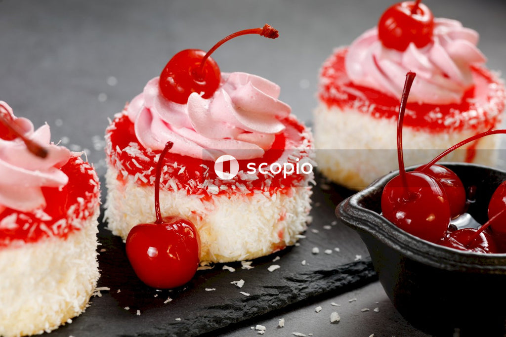 White and red cake with cherry on top