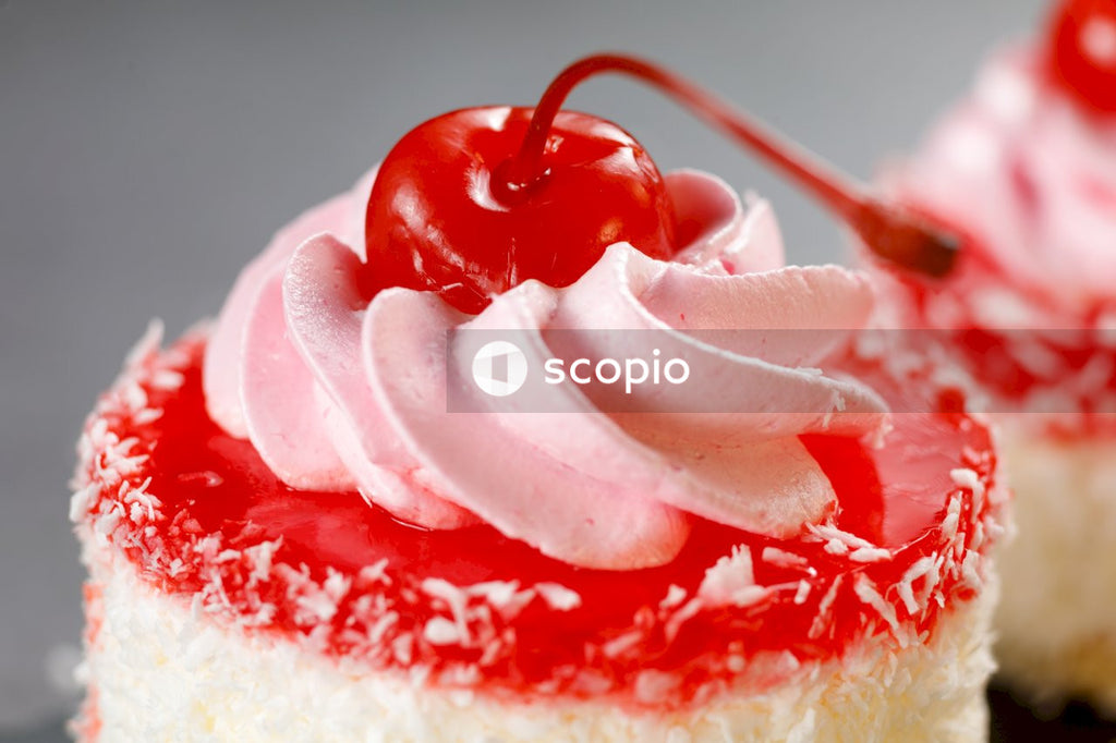 White and red cake with strawberry on top