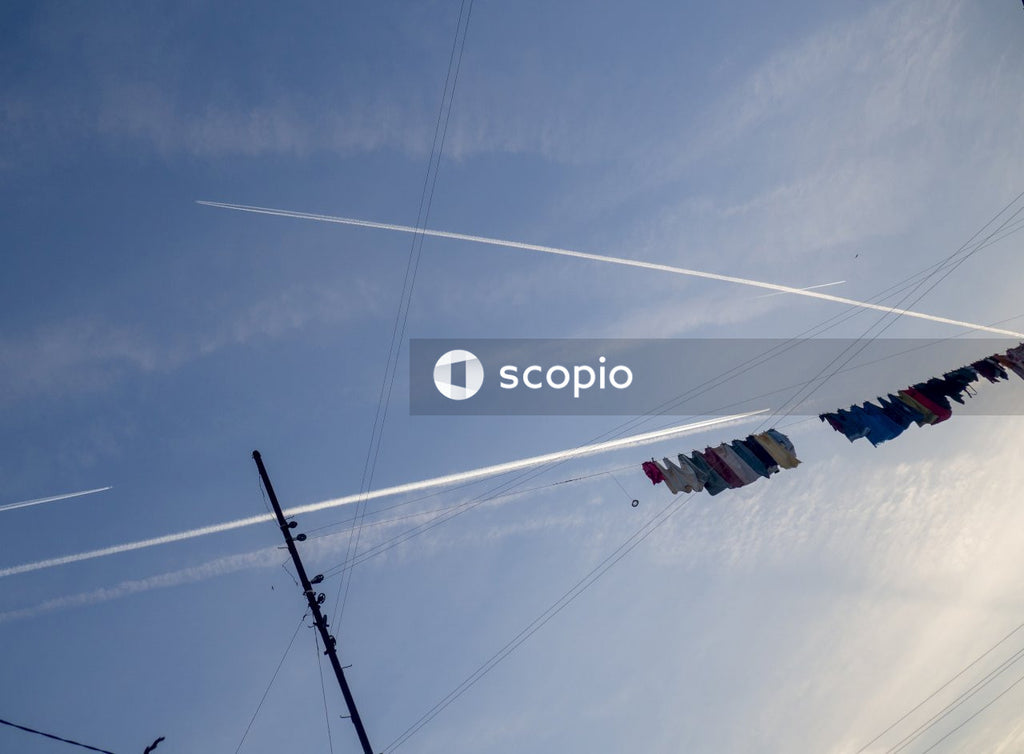White and red flag on black cable wire under blue sky