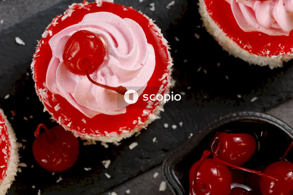 White and red icing on black tray