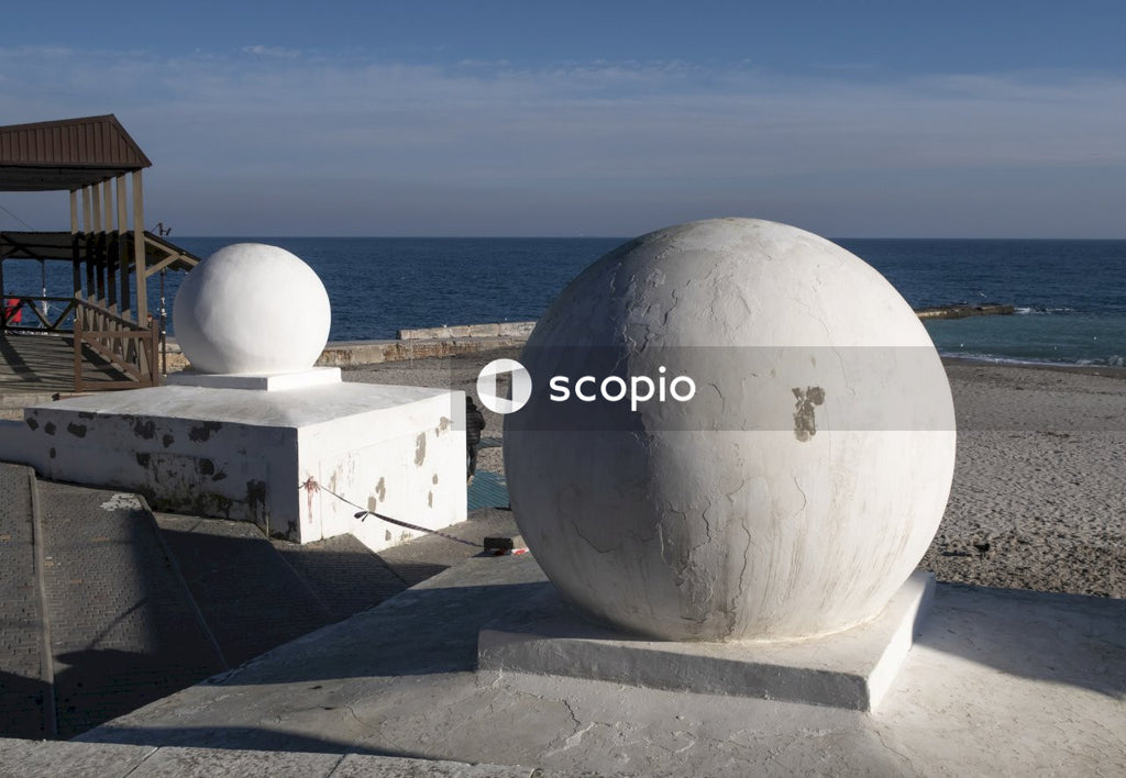White ball on gray concrete bench