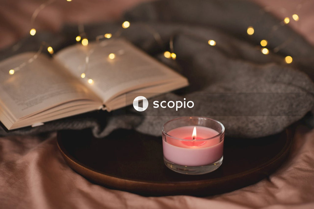 White candle on brown wooden round tray