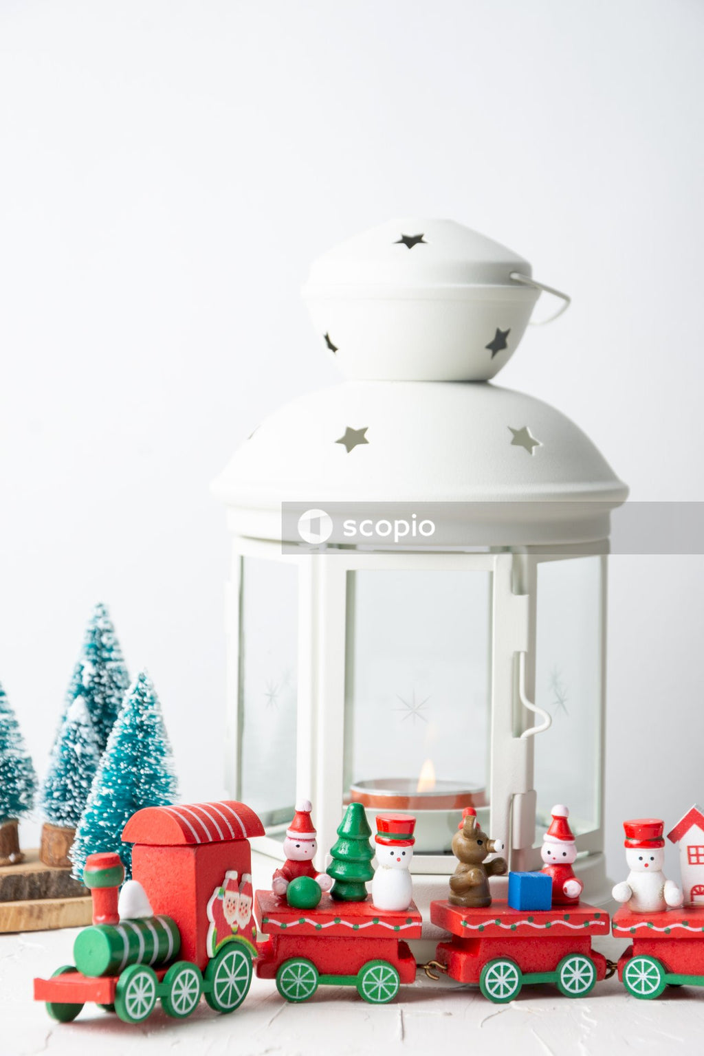 White ceramic candle lantern on red table cloth