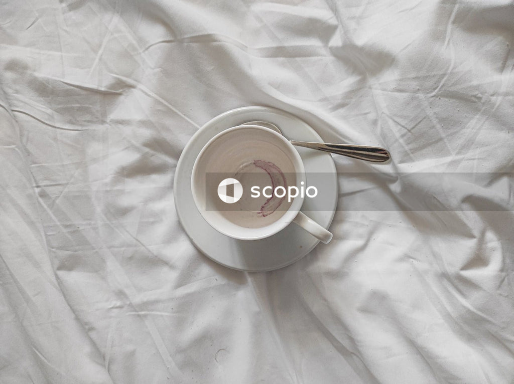 White ceramic mug with brown liquid inside