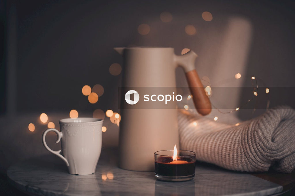 White ceramic mug with lighted candle